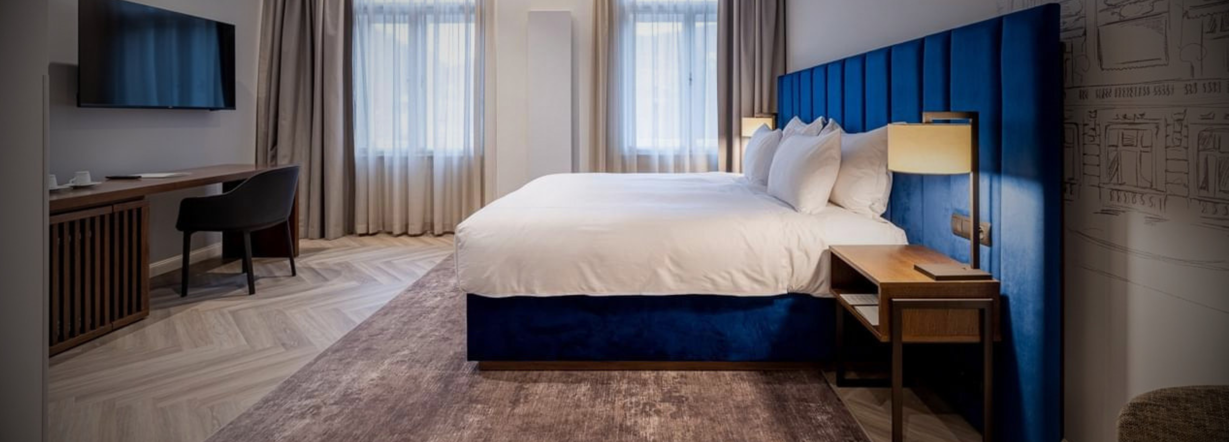 Hotel room furnished by UNAR — bed, headboard and nightstands made in Czech Republic